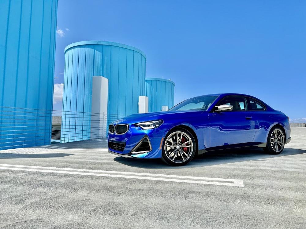 a blue car parked in front of a building