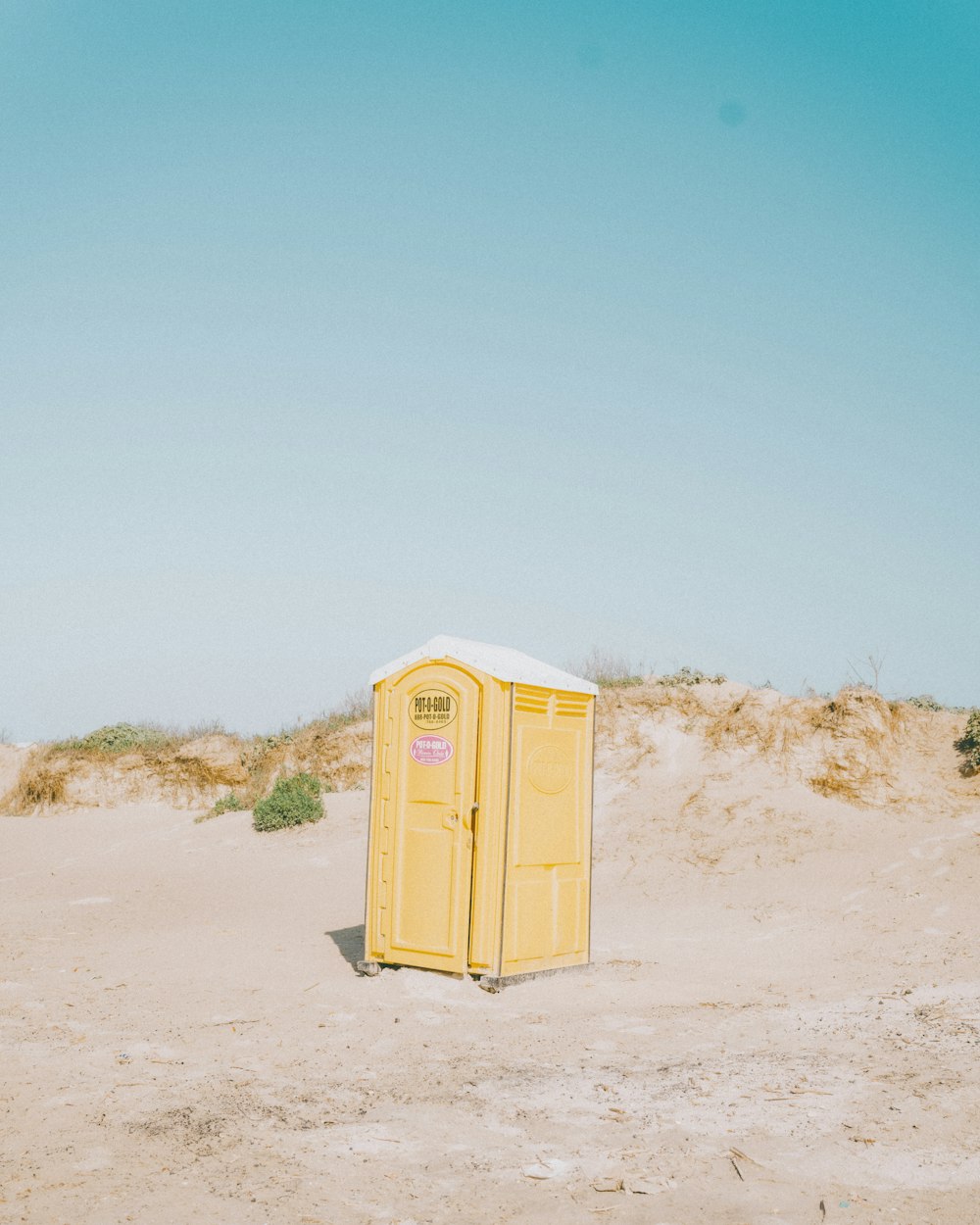 a small yellow box in the sand