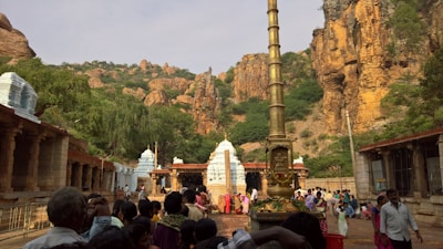 A vibrant group chanting Shiva mantras together in a temple courtyard.