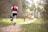 A group of trail runners enjoying a forest path surrounded by trees.
