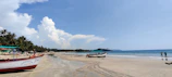 A serene beach scene with palm trees and boats at San Juan del Sur.
