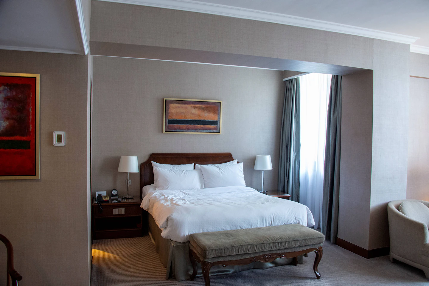 A bed with white bedding in a hotel room