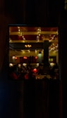 A cozy restaurant interior with warm orange and purple lighting.