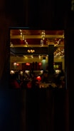 A warmly lit restaurant scene with happy guests enjoying their meals.