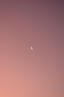 A serene, minimalist journal page with soft moon phases illustrated in calming pastel colors.