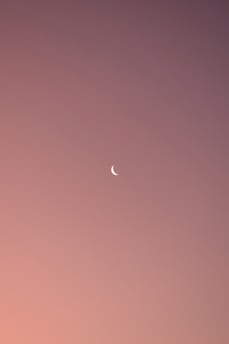 A serene, minimalist journal page with soft moon phases illustrated in calming pastel colors.