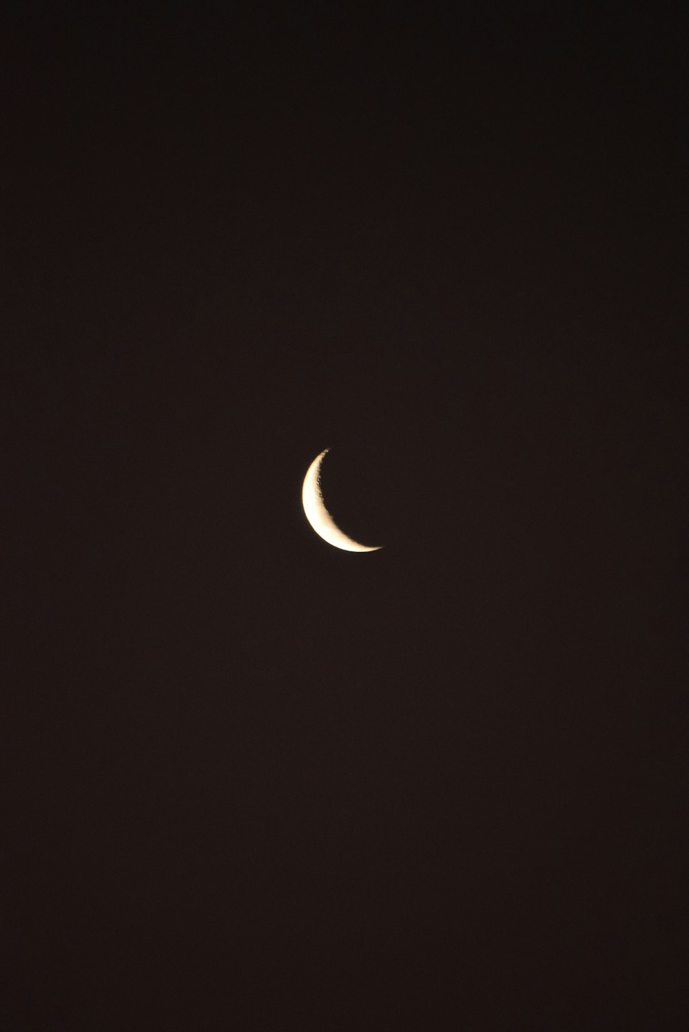 a crescent moon in a black sky