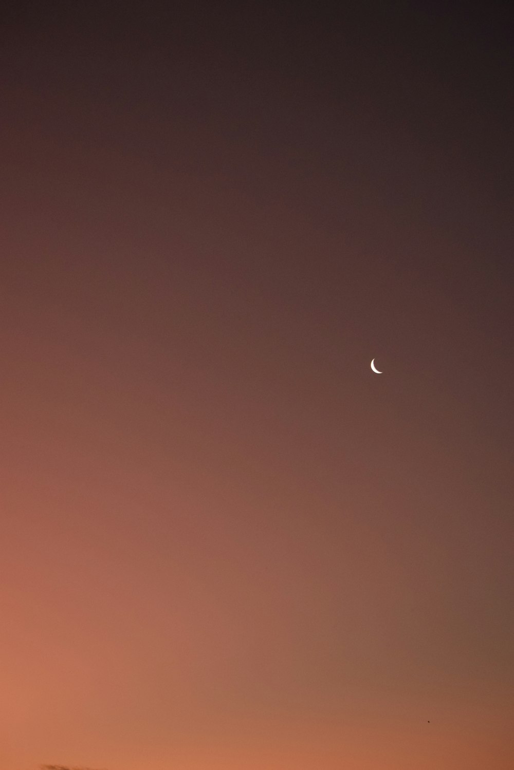 a crescent moon in a dark sky