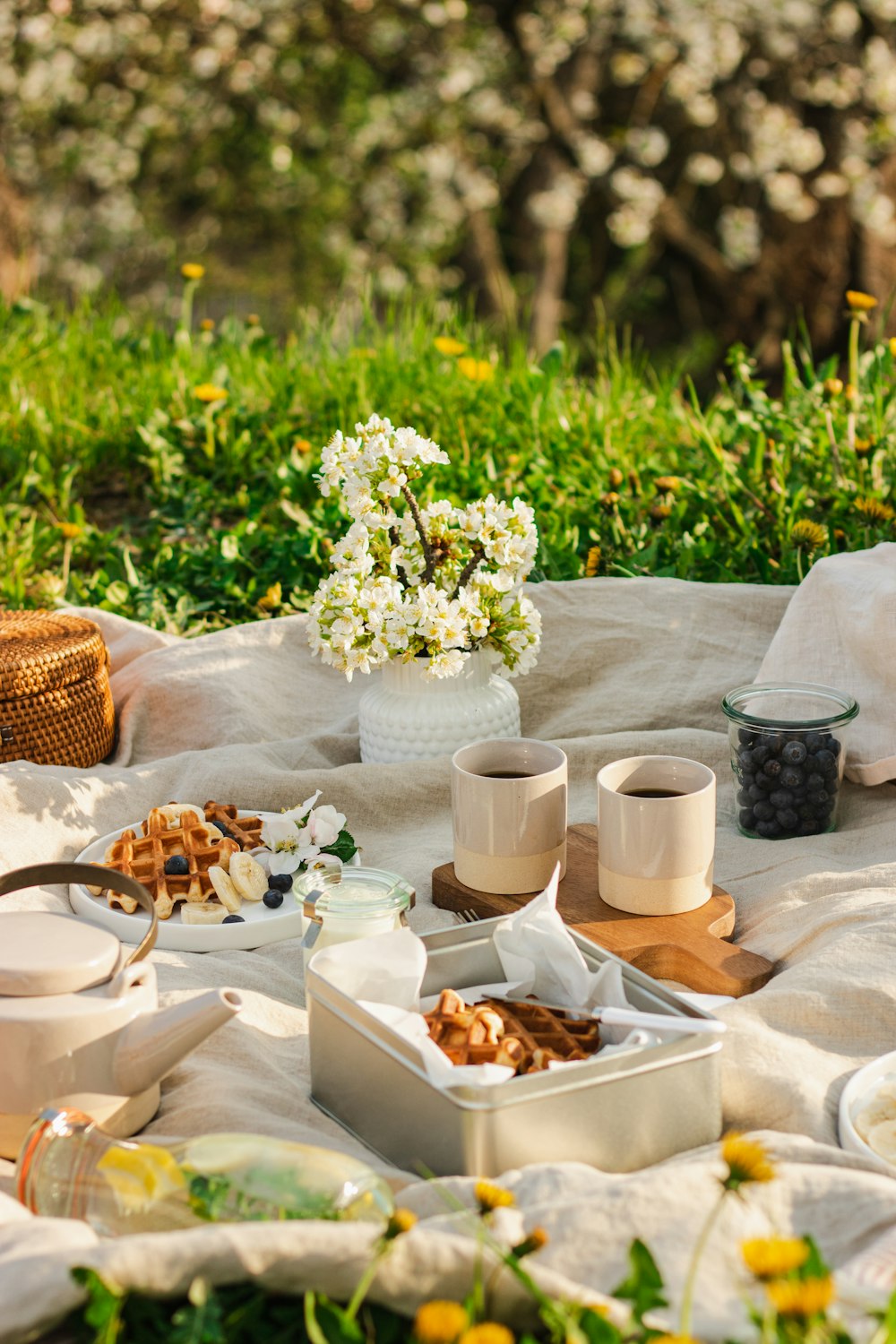 a table with flowers and food on it