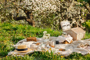 a picnic table with a basket and flowers