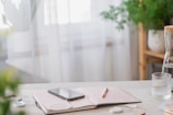 A tranquil workspace with a laptop and notepad on a desk.