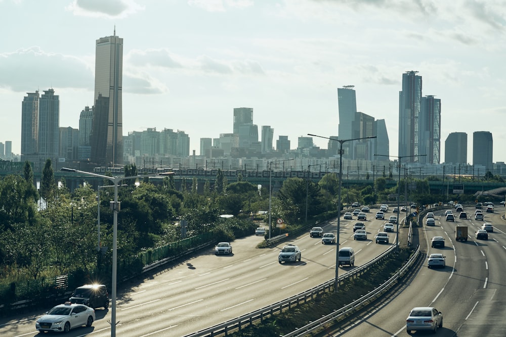 a freeway with cars on it and a city in the background