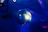 Children laughing and dancing inside a colorful disco dome with vibrant party lights.