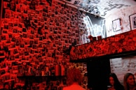 People laughing as they choose pictures to share from their mobile devices in a cozy room.