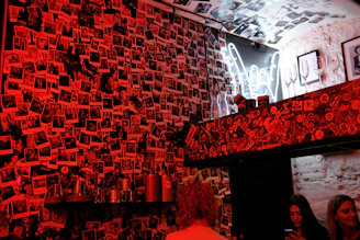 A lively gallery wall filled with colorful photos of past events, people smiling, dancing, and enjoying themselves amidst warm lighting.