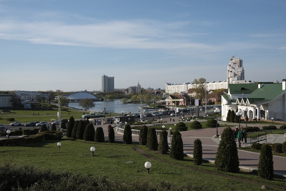 a park with a pond and buildings