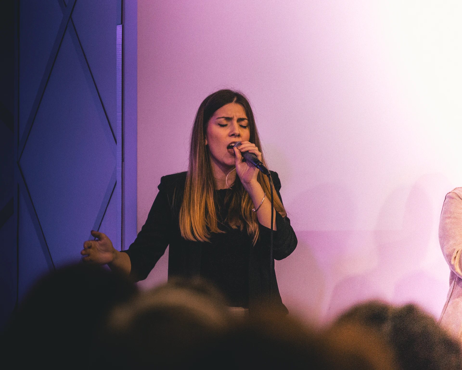 a woman singing into a microphone