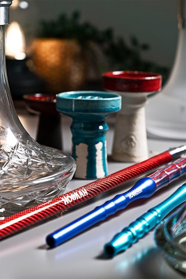 A beautifully arranged display of various hookah flavors and accessories on a wooden table.