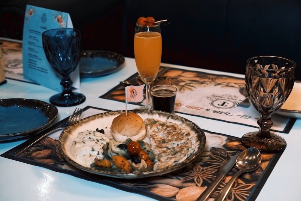 a plate of food and glasses on a table