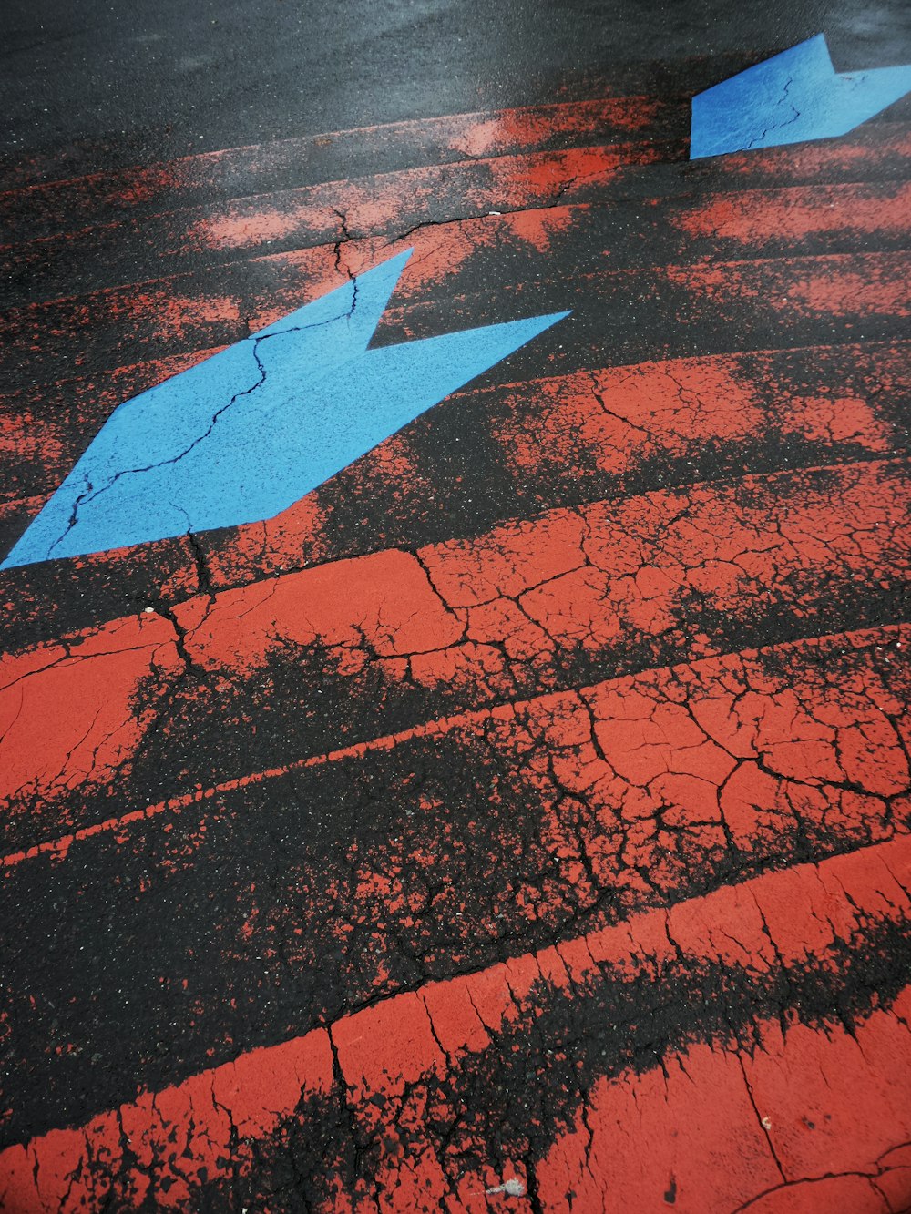 a blue arrow on a red surface