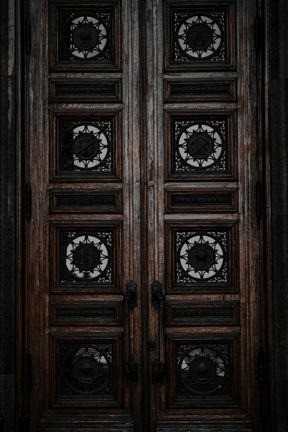 a wood door with a group of clocks on it