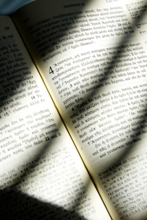 An open ancient Bible with golden light shining on the pages, symbolizing deep scriptural study.