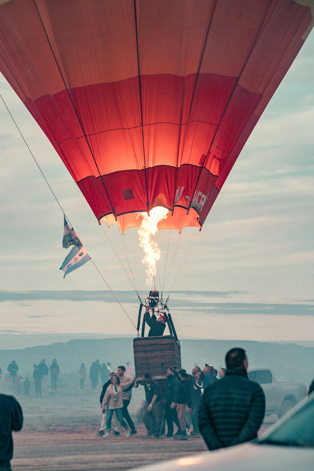a hot air balloon with people around it