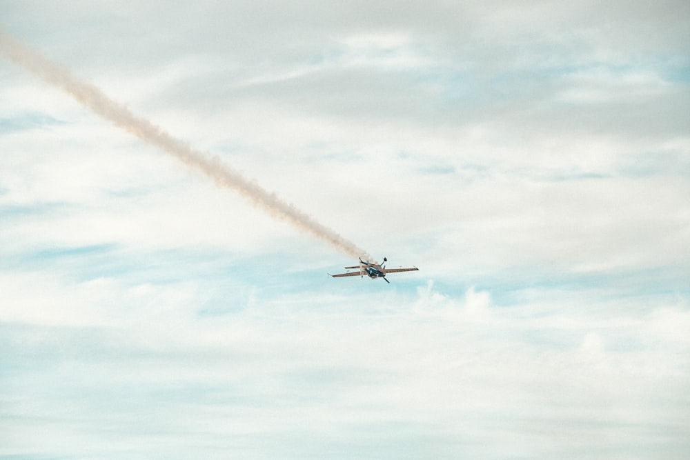 a plane flying with red smoke