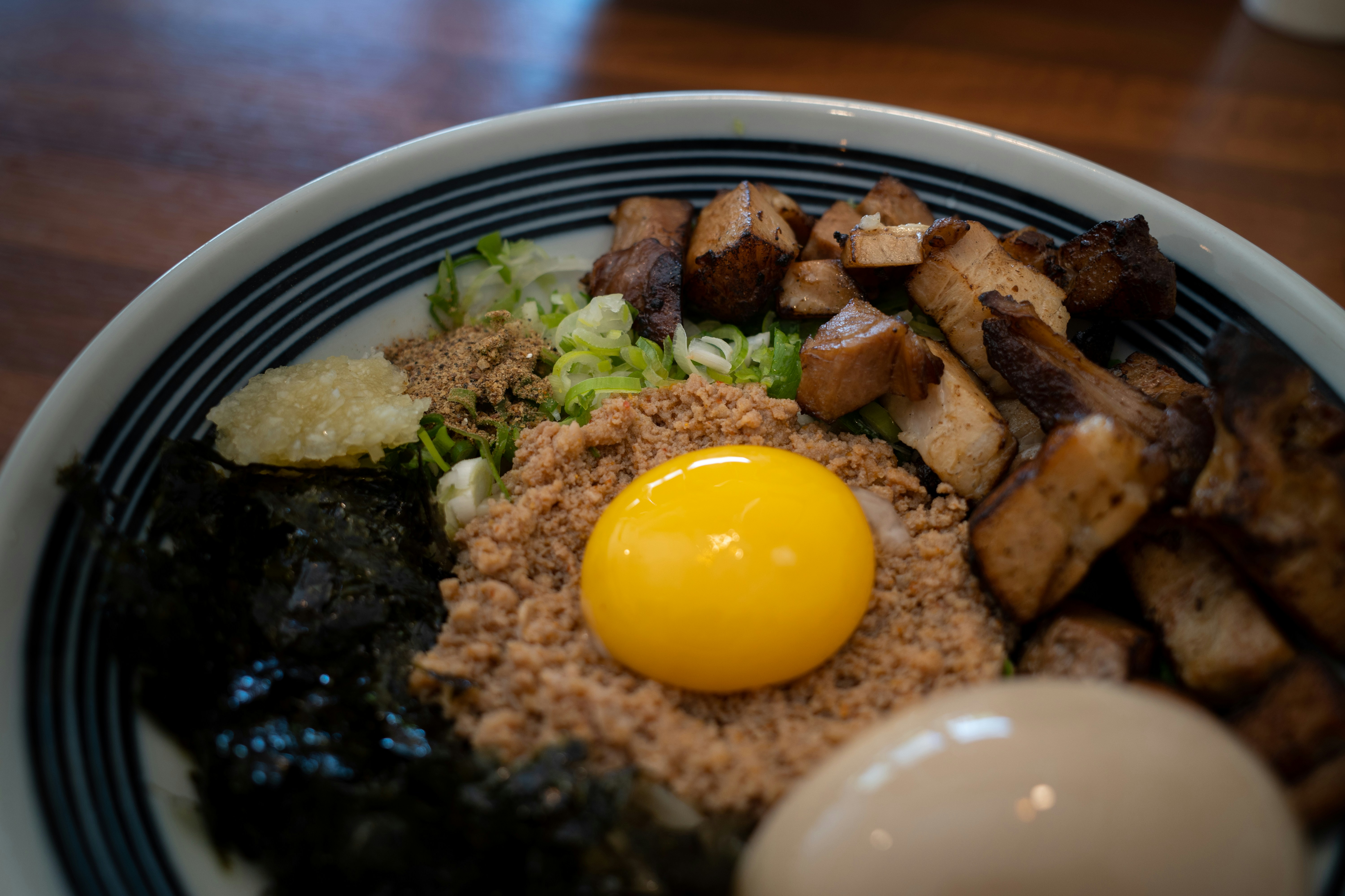 Rice bowl with egg yolk, seaweed and braised meat