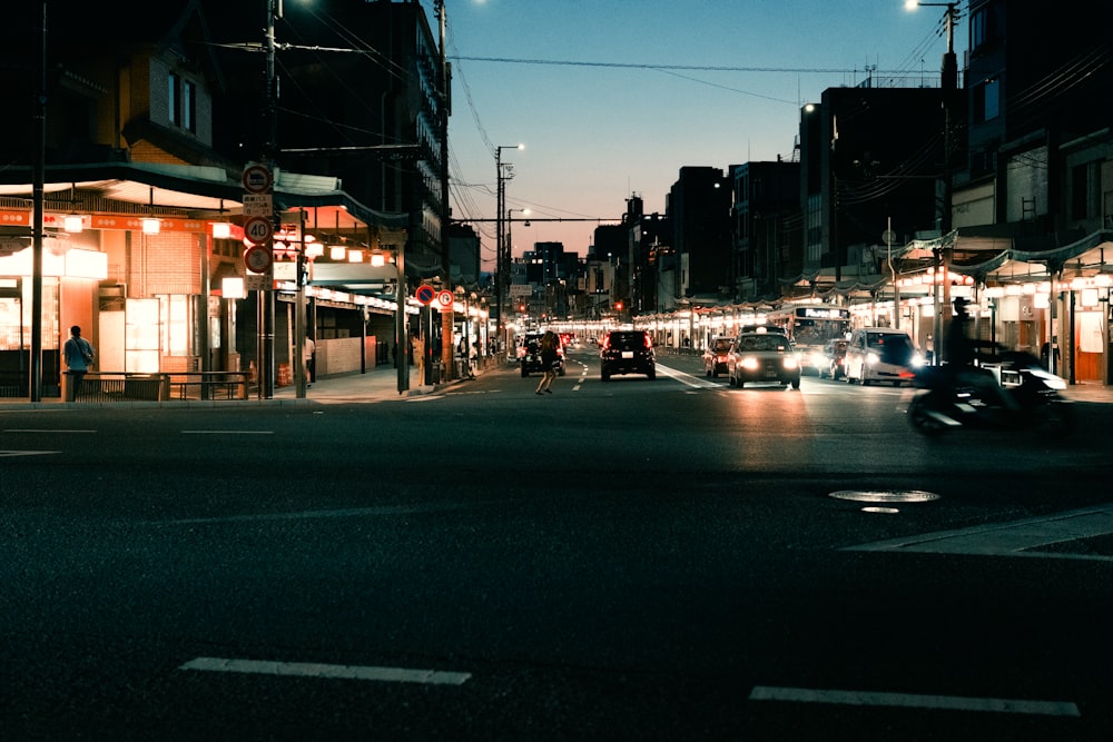 a city street with cars and people