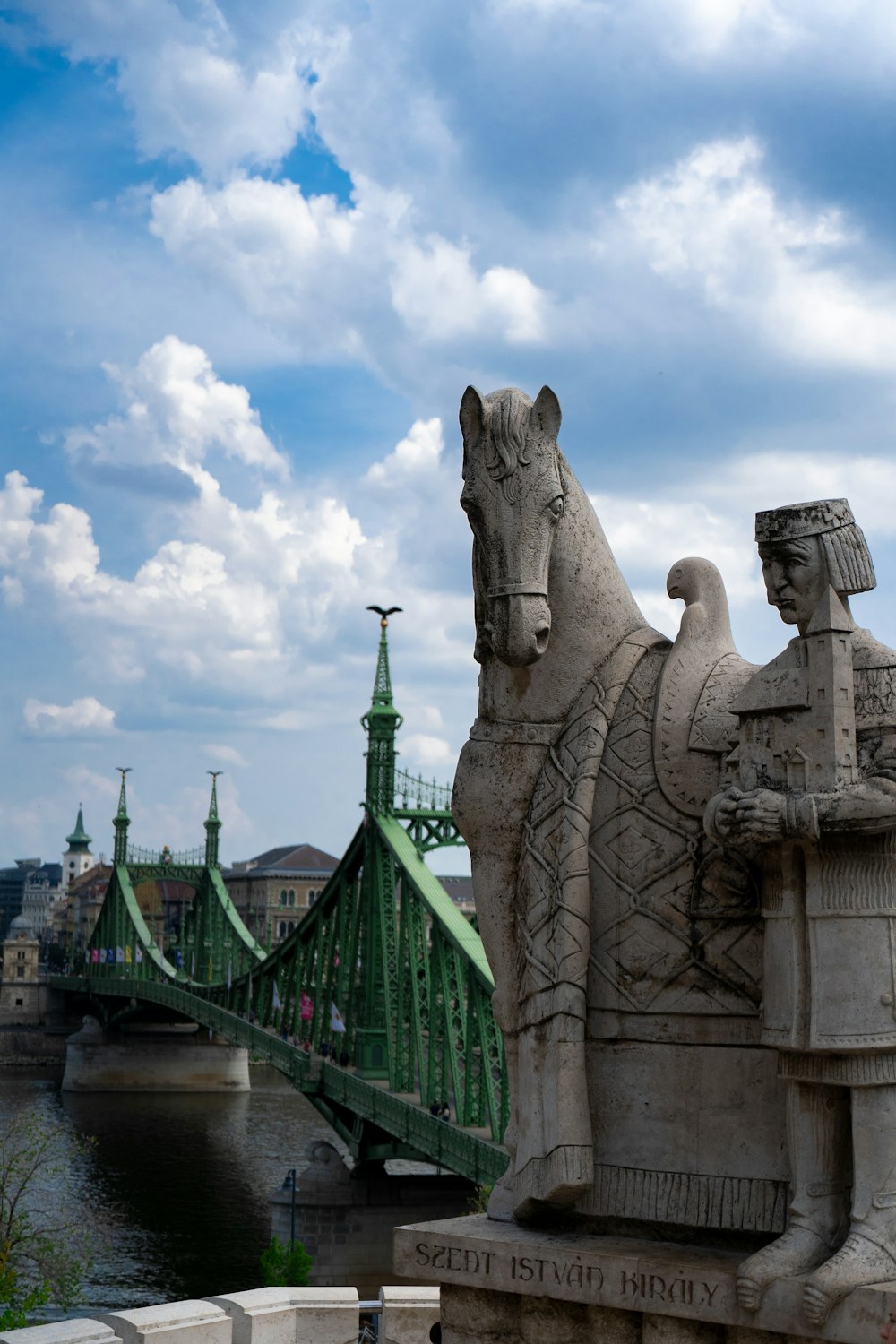 a bridge over a river with statues
