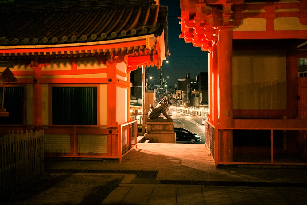 a building with a street and cars