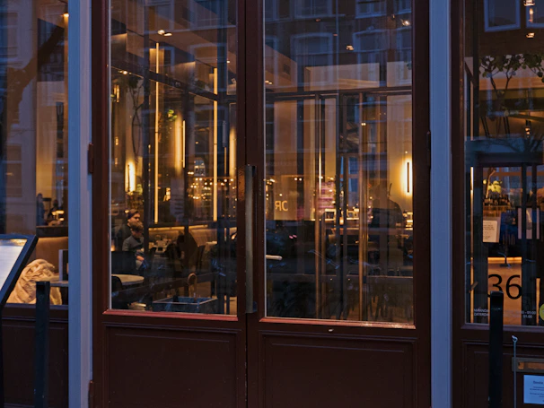 Cozy evening ambiance inside doclau with warm lighting and guests enjoying meals