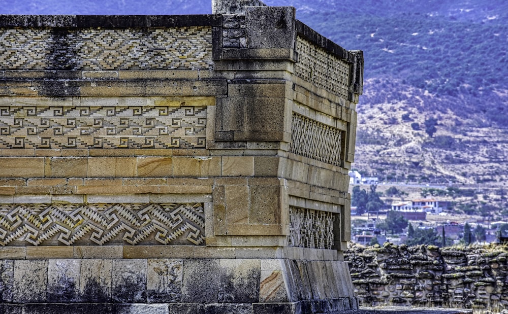 a stone building with a city in the background