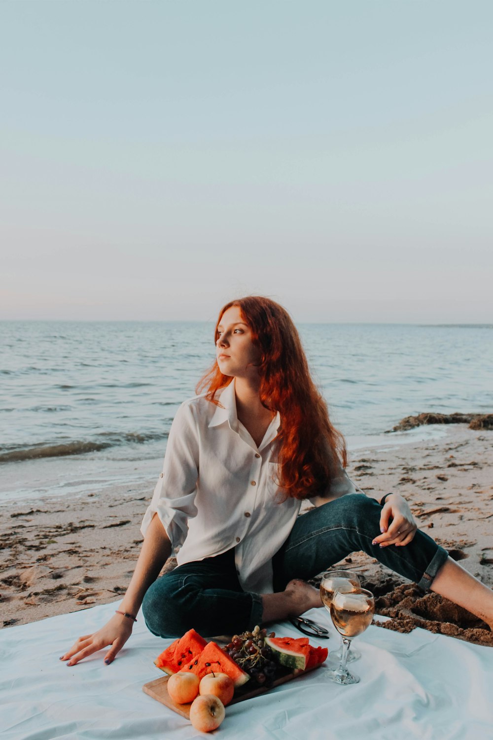 a woman sitting on a beach