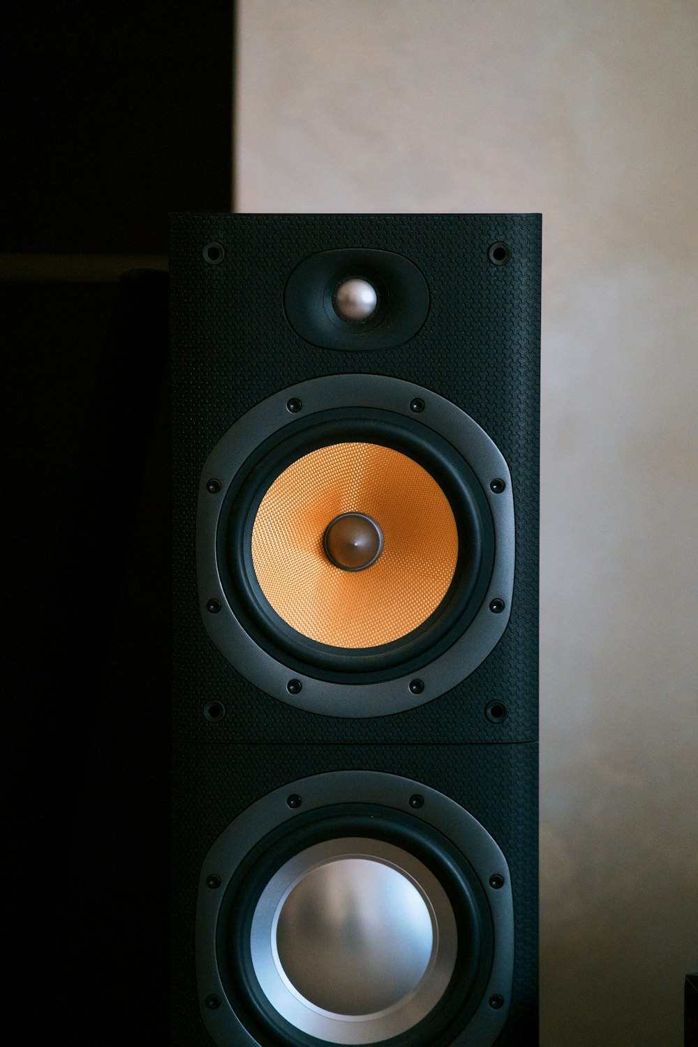 a black speaker with a round light