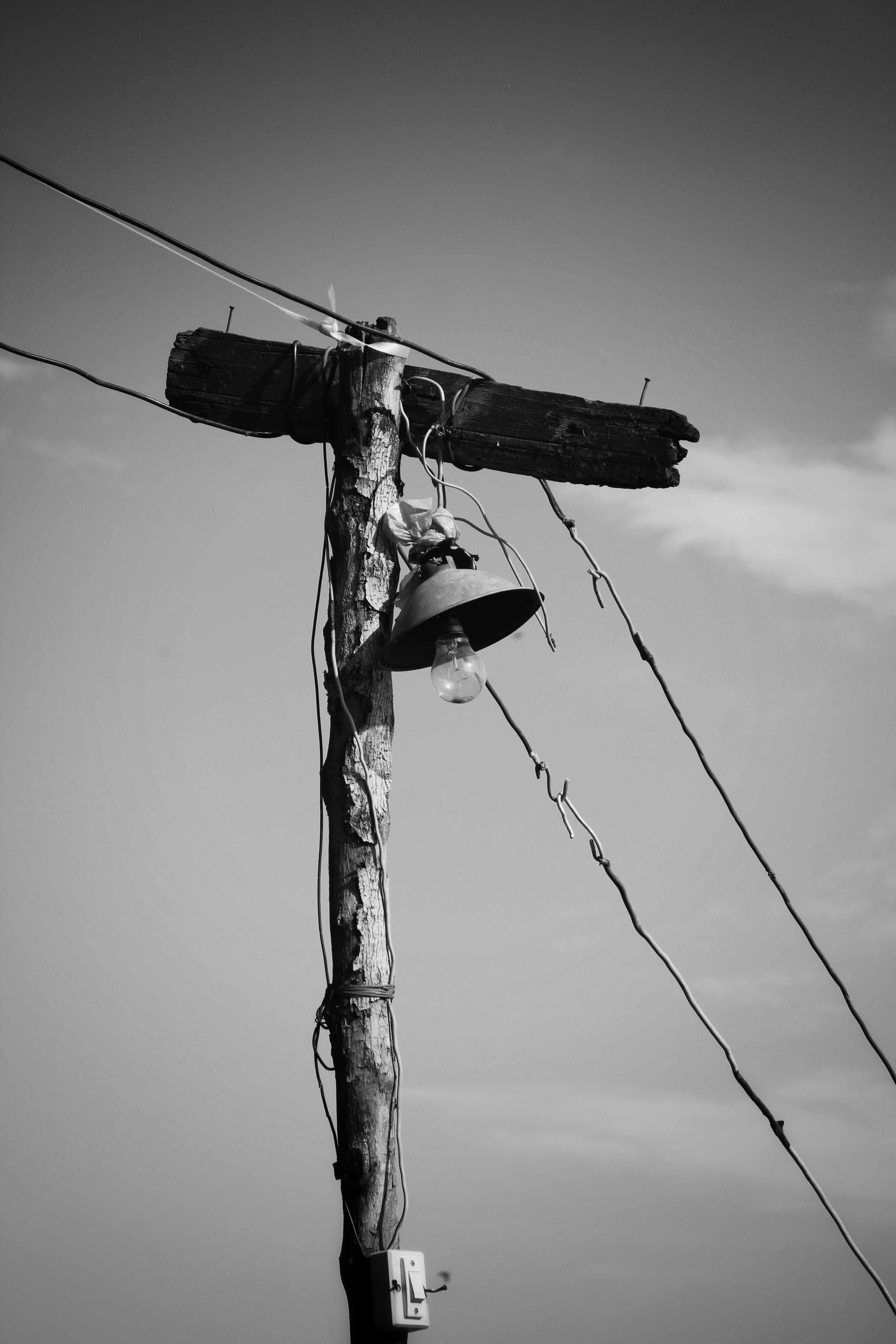 a telephone pole with a couple of people on it