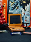 A vintage handheld gaming setup with the Game Boy Advance SP and classic game cartridges.