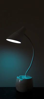 An abstract design lamp glowing softly on a minimalist wooden side table.