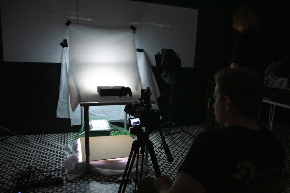 a person sitting in front of a projector screen