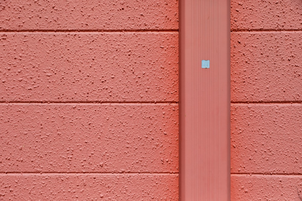 a white pole on a brick wall