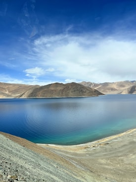 a body of water with hills in the background