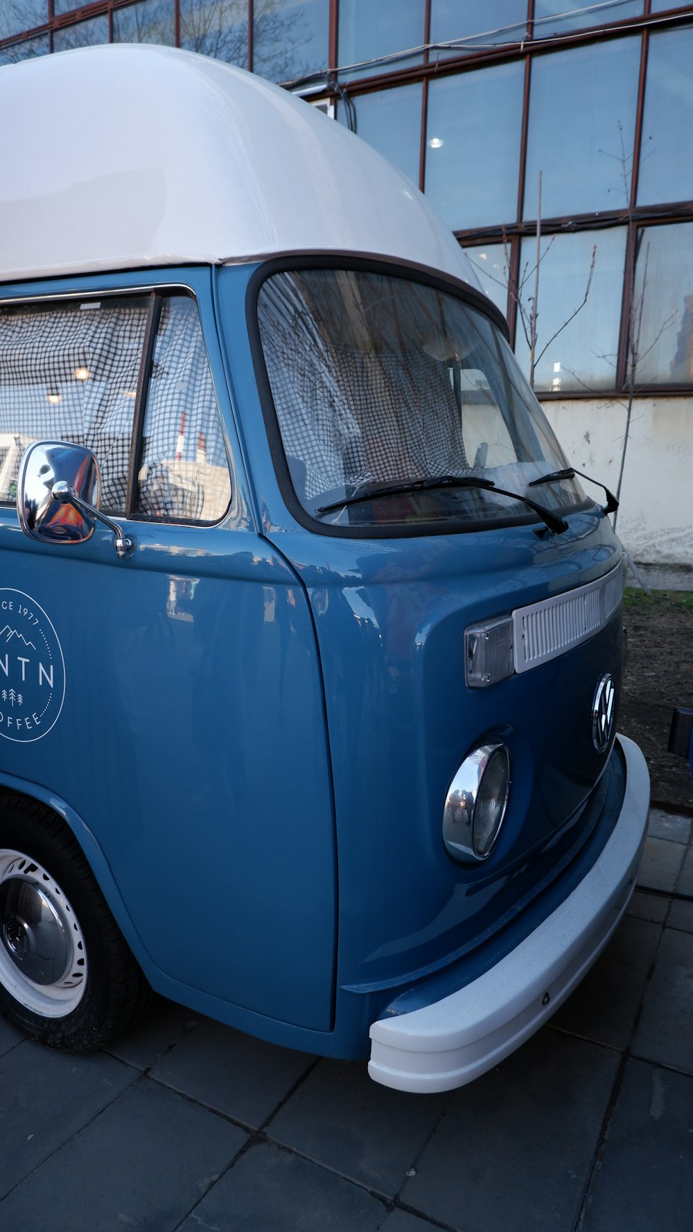 a blue car parked in front of a building