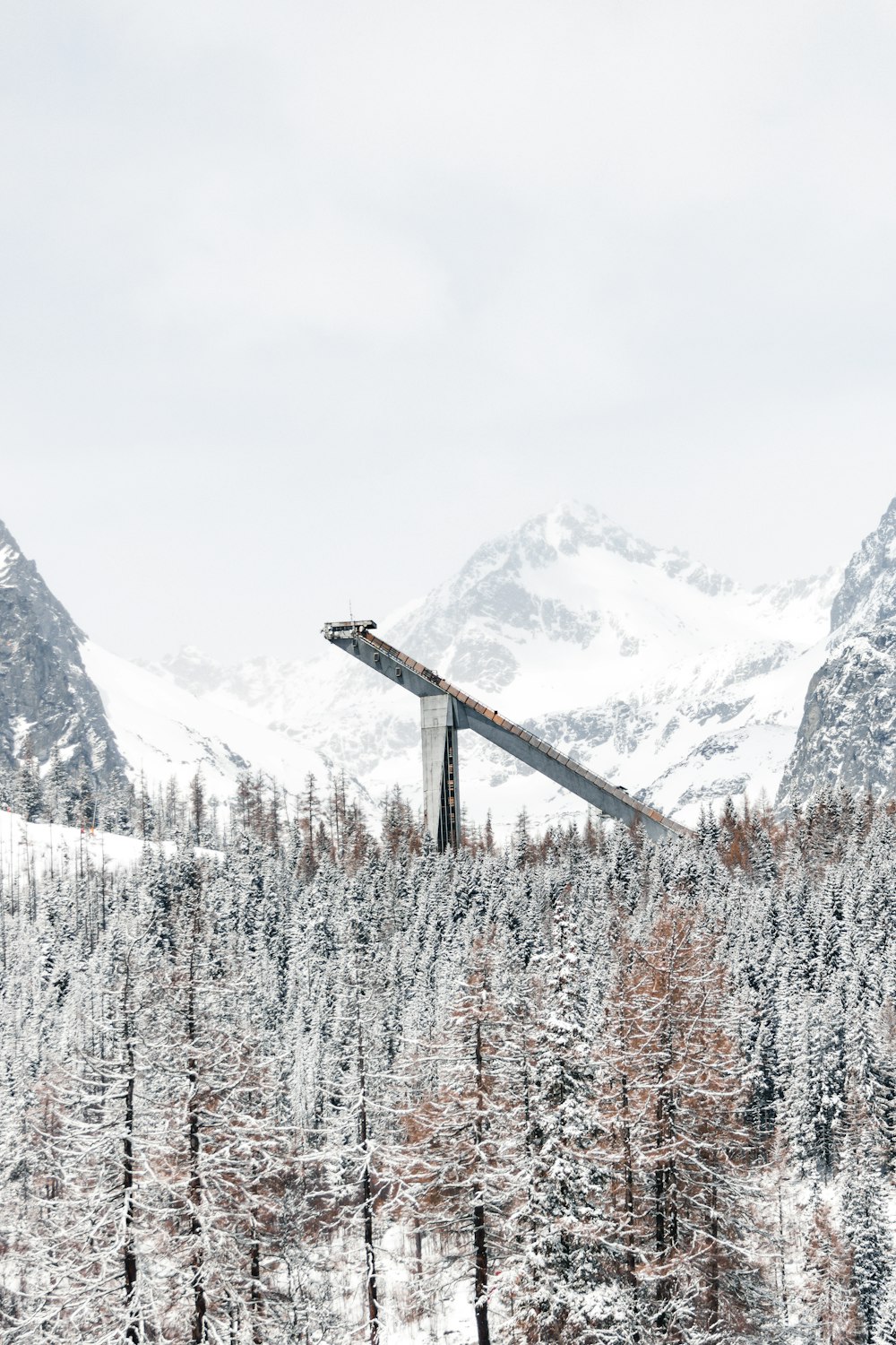 a bridge over a snowy mountain