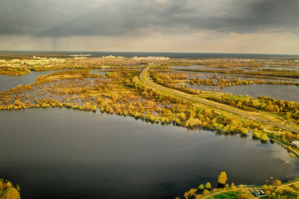 a river with a road and trees along it