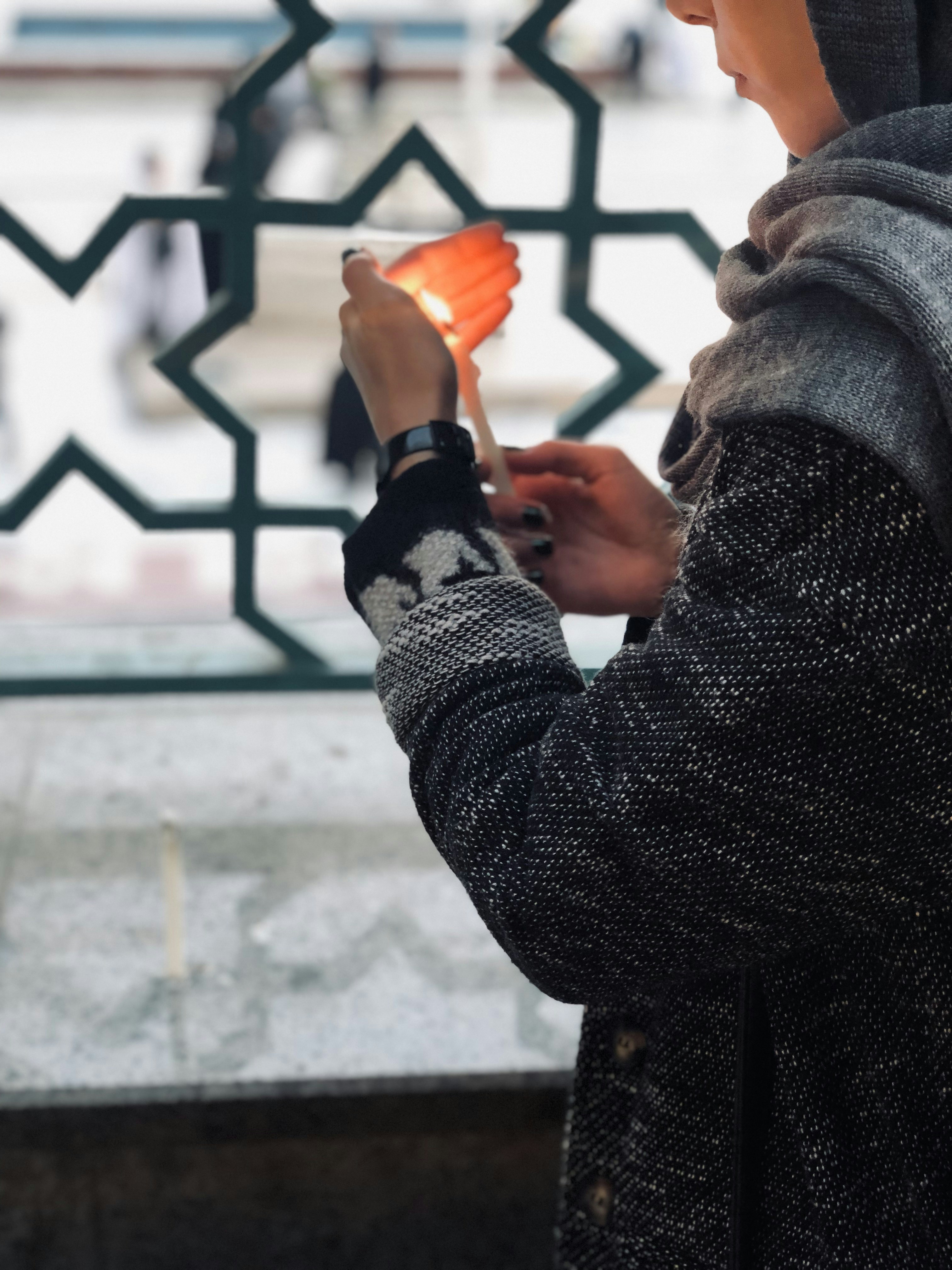 a person holding a small orange object