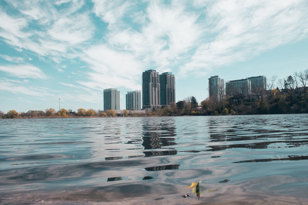 a body of water with a city in the background