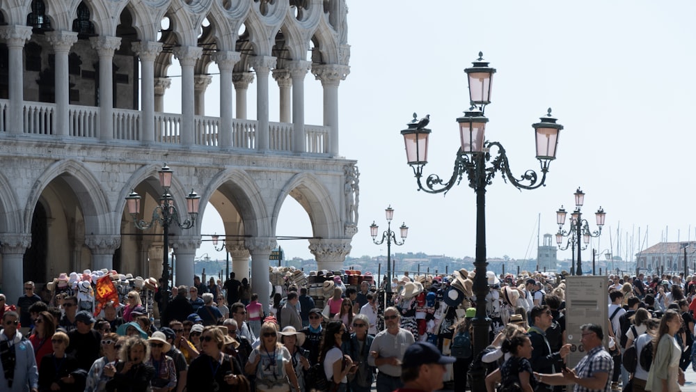 a crowd of people in front of a white building