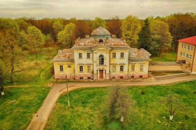 a large house with a grass field in front of it