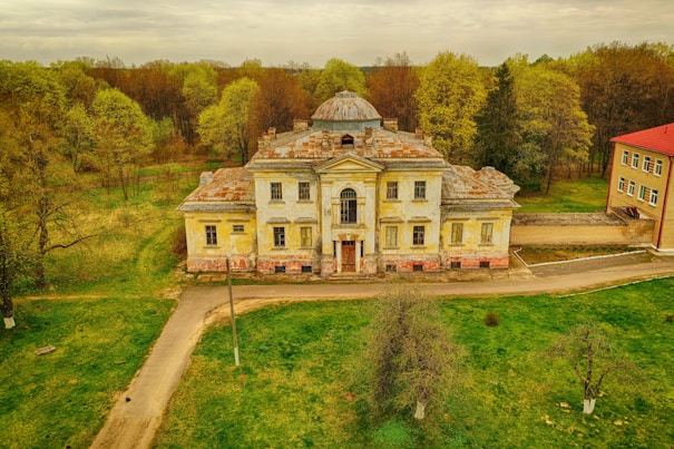 a large house with a grass field in front of it